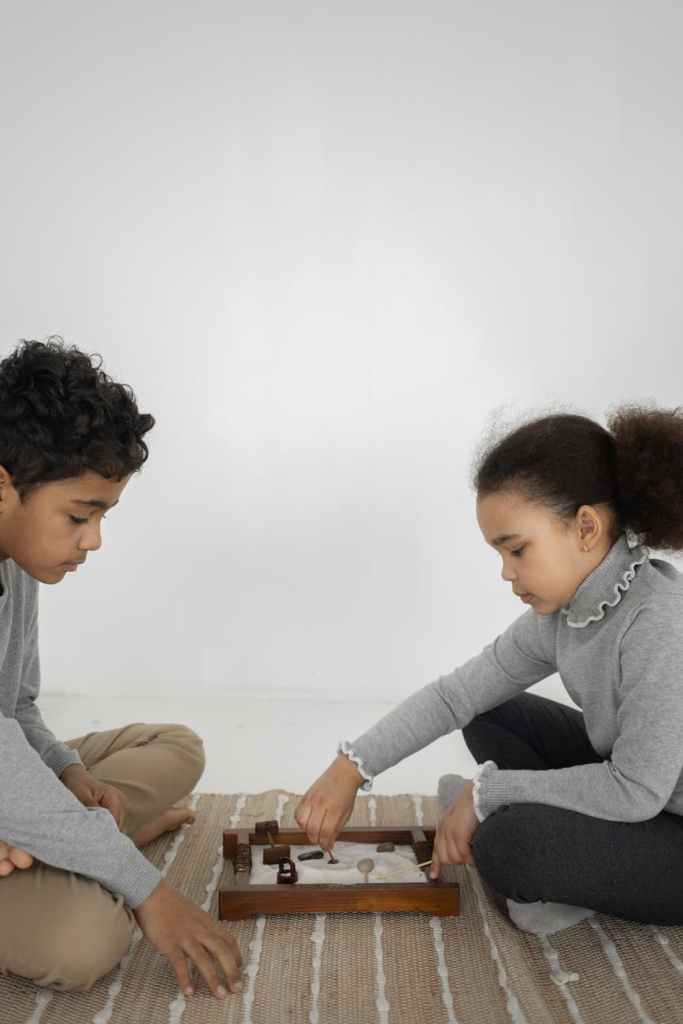ethnic kids playing with toys on floor